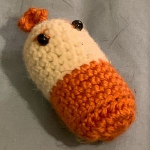 Handmade hand crocheted plush pill. Orange and tan